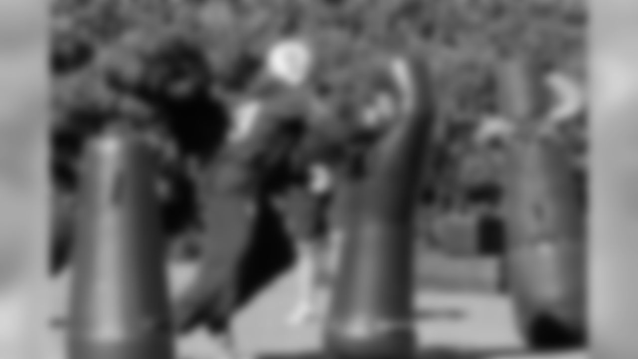 DT Tommy Kelly hits the tackling dummy. Photo by Tony Gonzales.