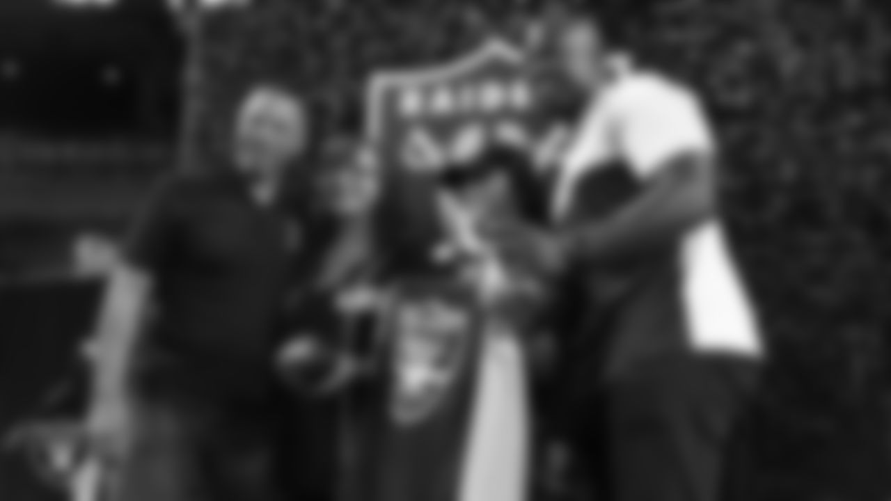 Las Vegas Raiders alumni Rod Woodson and Akbar Gbajabiamila pose for a photo with fans during the Season Ticket Member Appreciation Fan Fest at Allegiant Stadium.