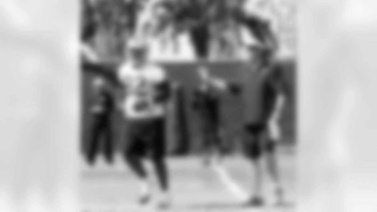TE Richard Gordon listens to OC Greg Knapp as he runs back to the offense.