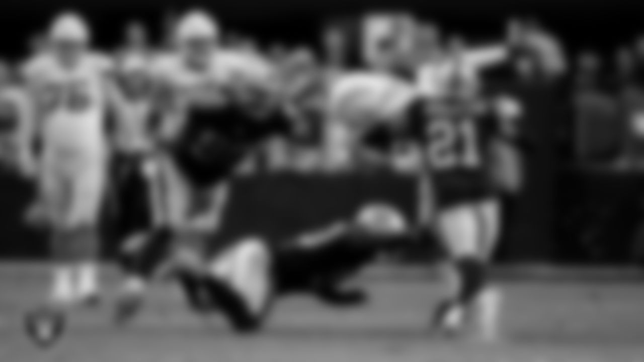 Las Vegas Raiders defensive lineman Jerry Tillery (90), linebacker Jayon Brown (50) and cornerback Amik Robertson (21) make a tackle during the regular season home game against the Los Angeles Chargers at Allegiant Stadium.