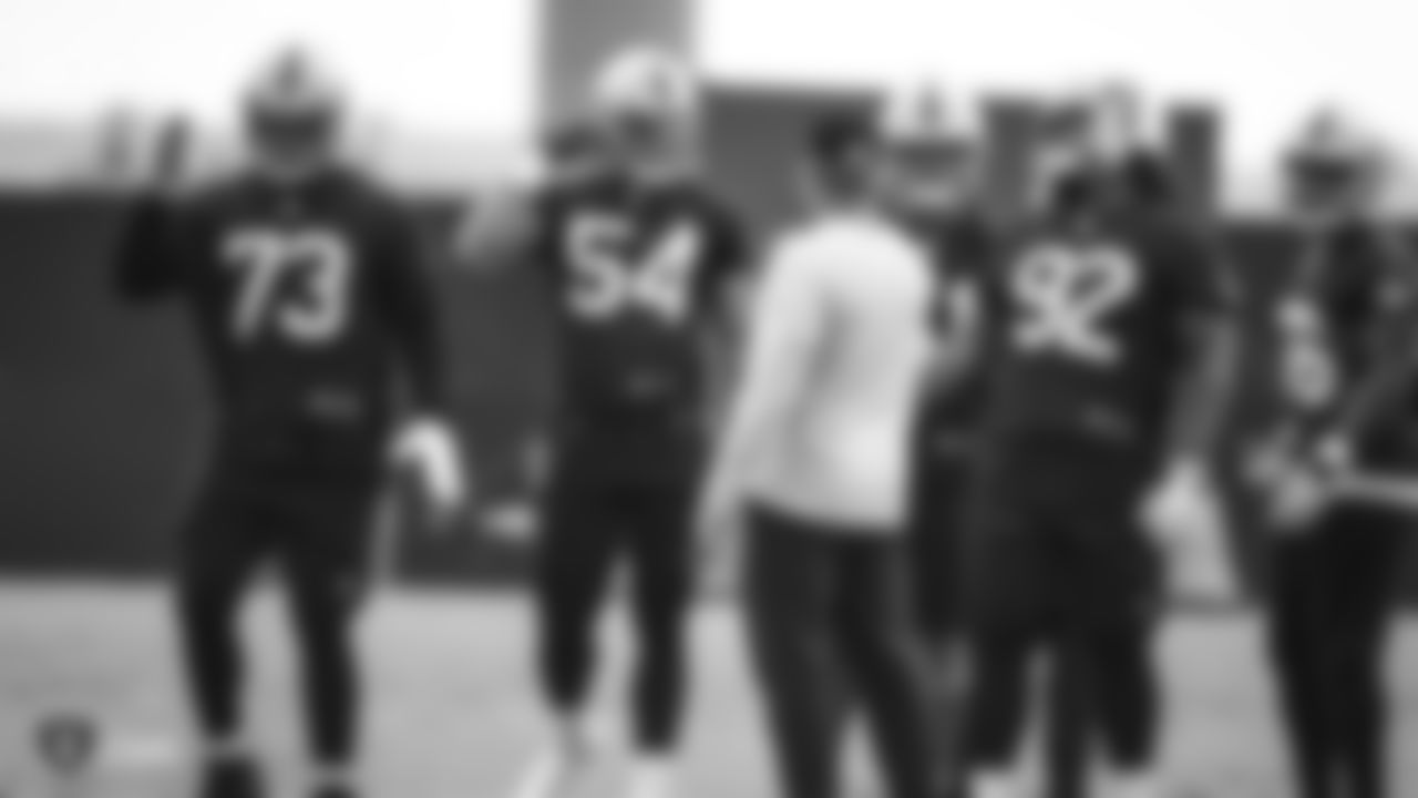 Raiders defensive end Kendall Donnerson (54) talks with Head Coach Jon Gruden during practice.