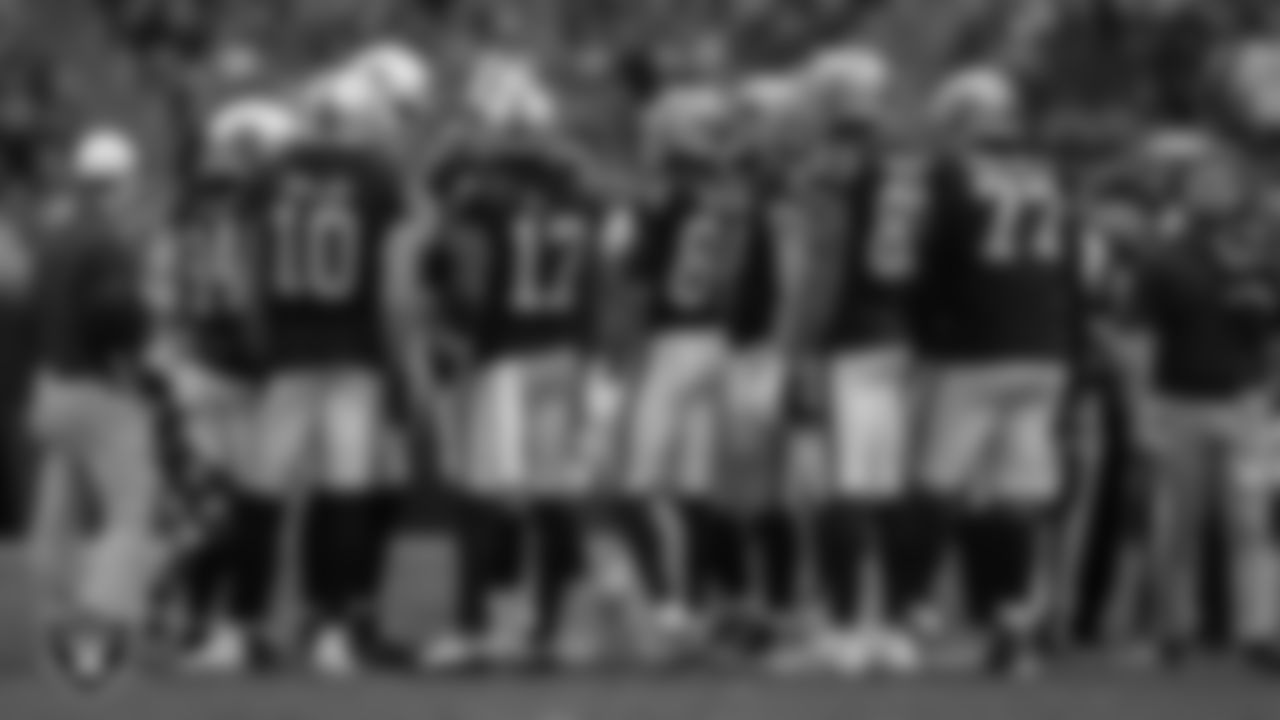 The Las Vegas Raiders offense huddle during the regular season home game against the Denver Broncos at Allegiant Stadium.