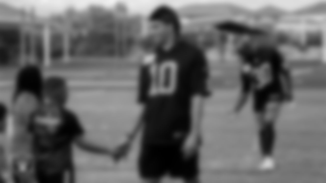 Las Vegas Raiders wide receiver Mack Hollins (10) high-fives a participant during a Fuel Up to Play 60 football clinic.
