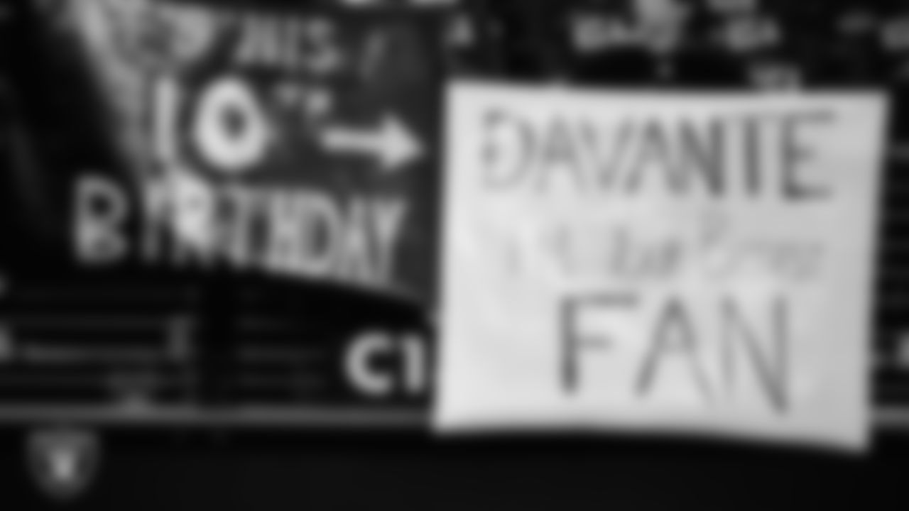 Las Vegas Raiders fans with signs before the regular season home game against the Los Angeles Chargers at Allegiant Stadium.