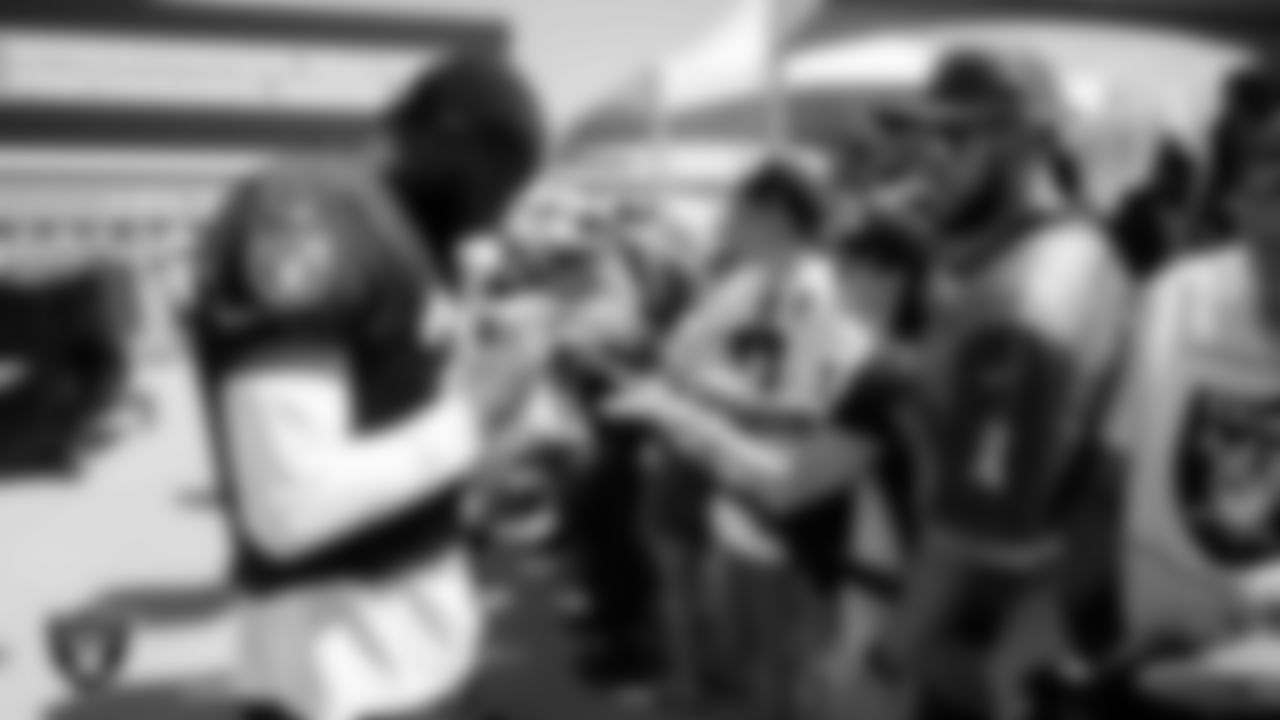 Las Vegas Raiders cornerback Brandon Facyson (31) signs autographs for fans after practice at 2023 Training Camp at Intermountain Health Performance Center.