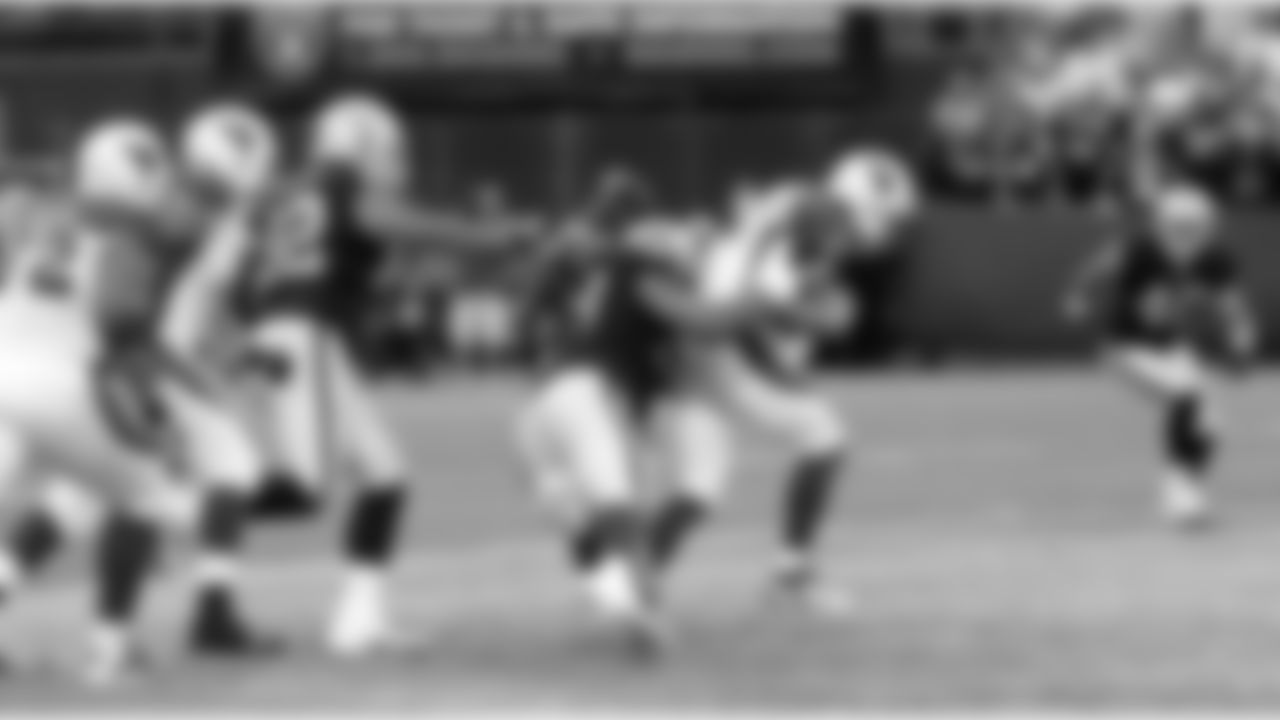 DT Tommy Kelly gets to the QB.