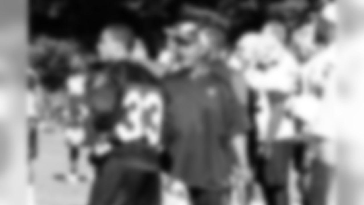 Offensive Coordinator Hue Jackson and DB Tyvon Branch talk about the previous play. Photo By Tony Gonzales.