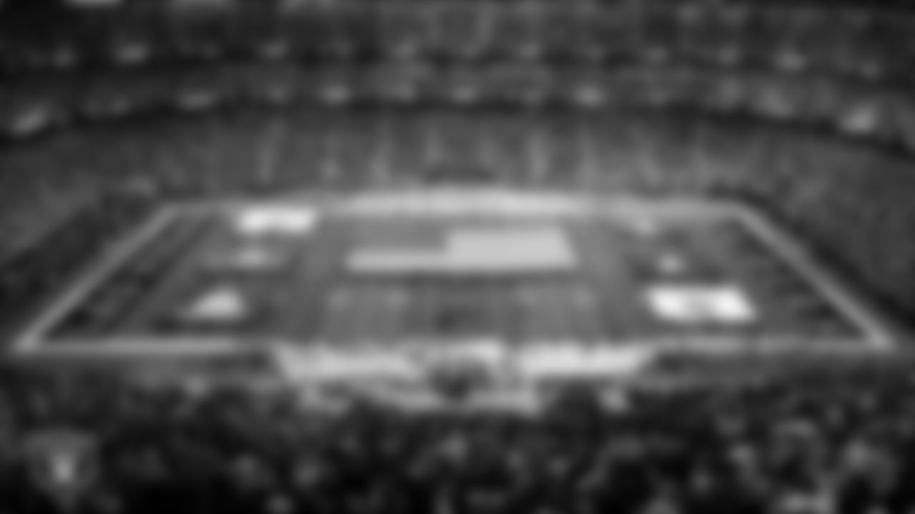 The American flag and flags from all six branches of the military are displayed by Personal Seat License (PSL) holder veterans and USAF reenlistment members on the field during the national anthem before the Las Vegas Raiders regular season home game against the Cincinnati Bengals.