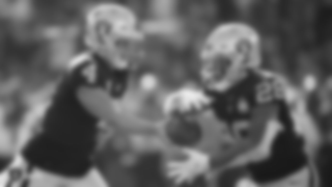 Raiders quarterback Derek Carr (4) hands the ball off to running back Josh Jacobs (28) during the regular season game against the Detroit Lions.
