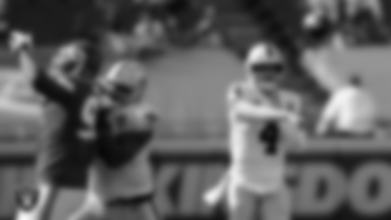 Las Vegas Raiders tackle Denzelle Good (71) and quarterback Derek Carr (4) during the regular season game against the Kansas City Chiefs at Arrowhead Stadium.