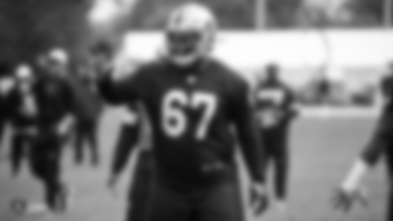 Raiders guard Lester Cotton Sr. (67) stands on the field during practice.