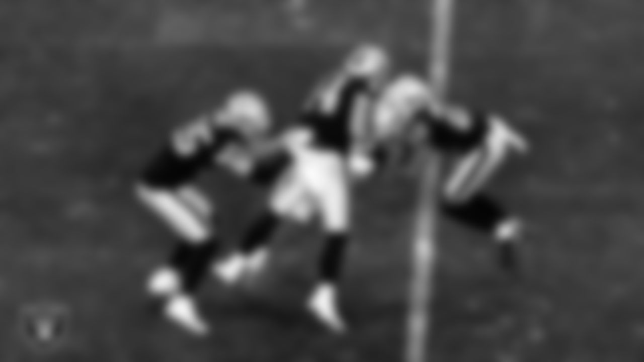 Las Vegas Raiders safety Erik Harris (25), linebacker Nick Kwiatkoski (44) and cornerback Keisean Nixon (22) make a tackle during the regular season home game against the Los Angeles Chargers.