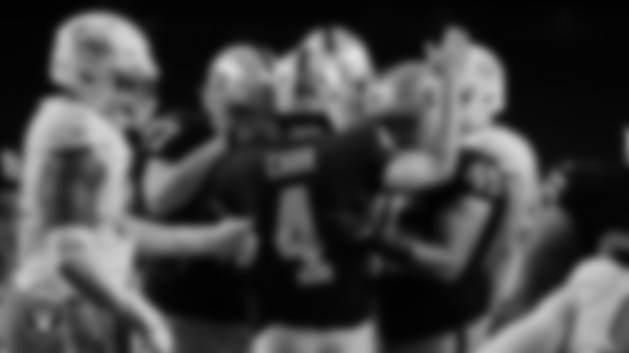 Las Vegas Raiders quarterback Derek Carr (4) celebrates with tight end Foster Moreau (87) and fullback Alec Ingold (45) after rushing for a 1-yard touchdown during the regular season home game against the Miami Dolphins.