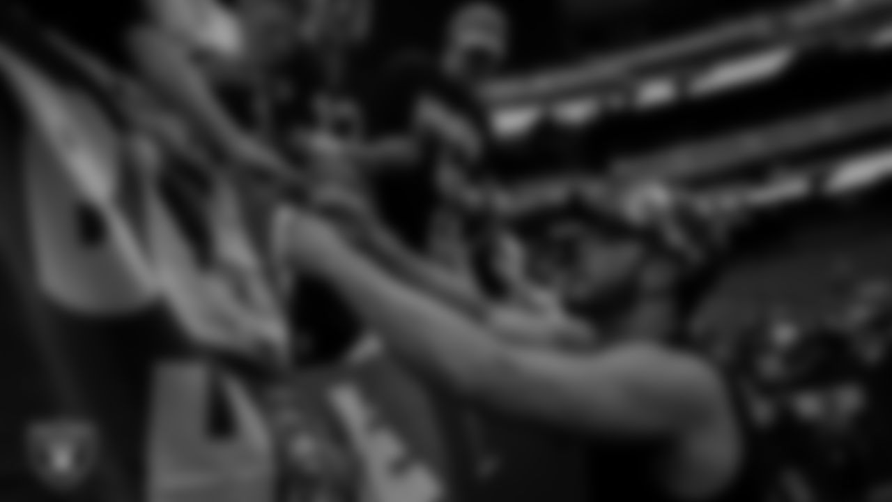 Las Vegas Raiders quarterback Derek Carr (4) signs autographs for fans before the preseason home game against the Minnesota Vikings at Allegiant Stadium.