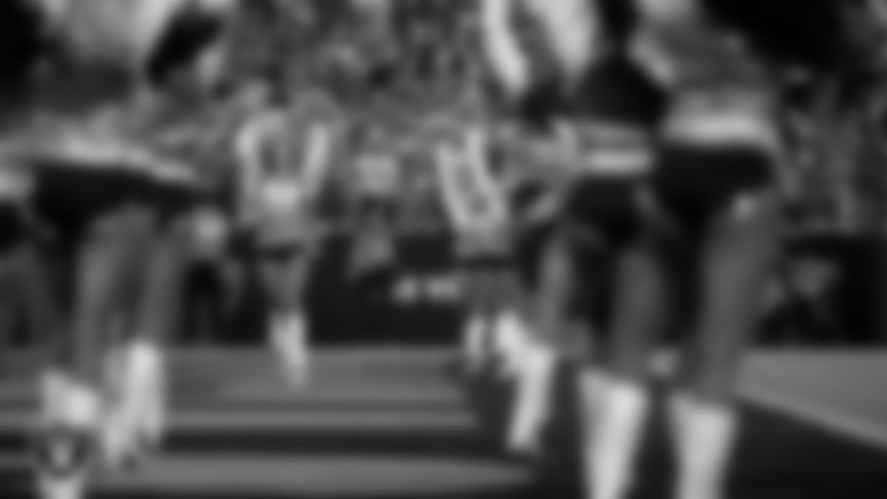 Raiderette Camryn walks onto the field for a performance during the regular season home game against the Green Bay Packers at Allegiant Stadium.