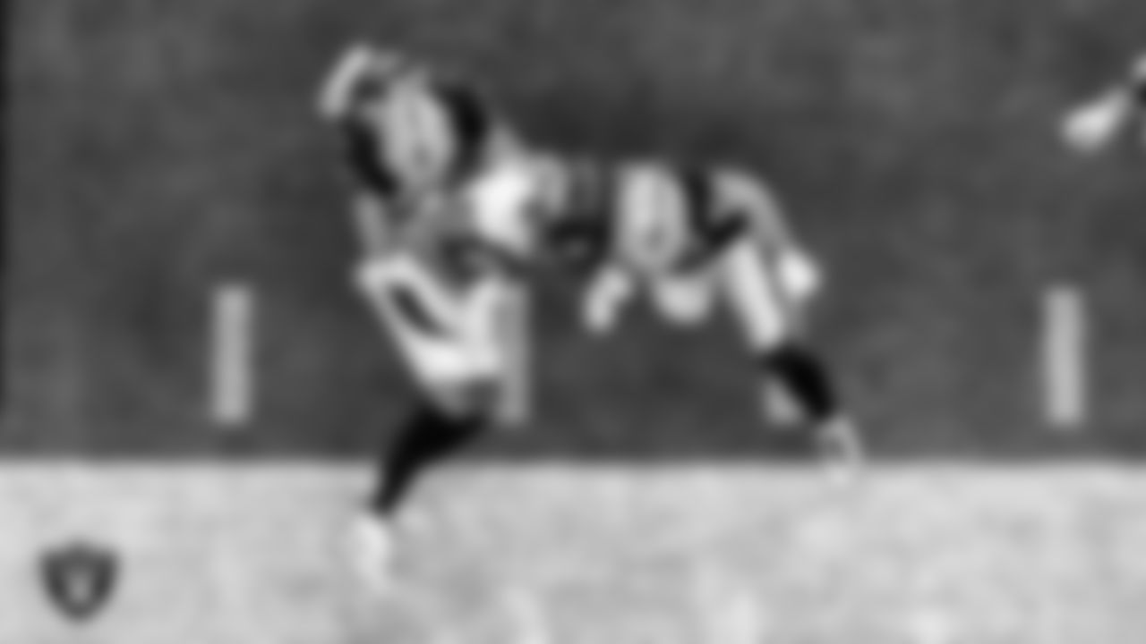 Las Vegas Raiders cornerback Trayvon Mullen (27) and safety Erik Harris (25) make a tackle during the regular season home game against the Denver Broncos.