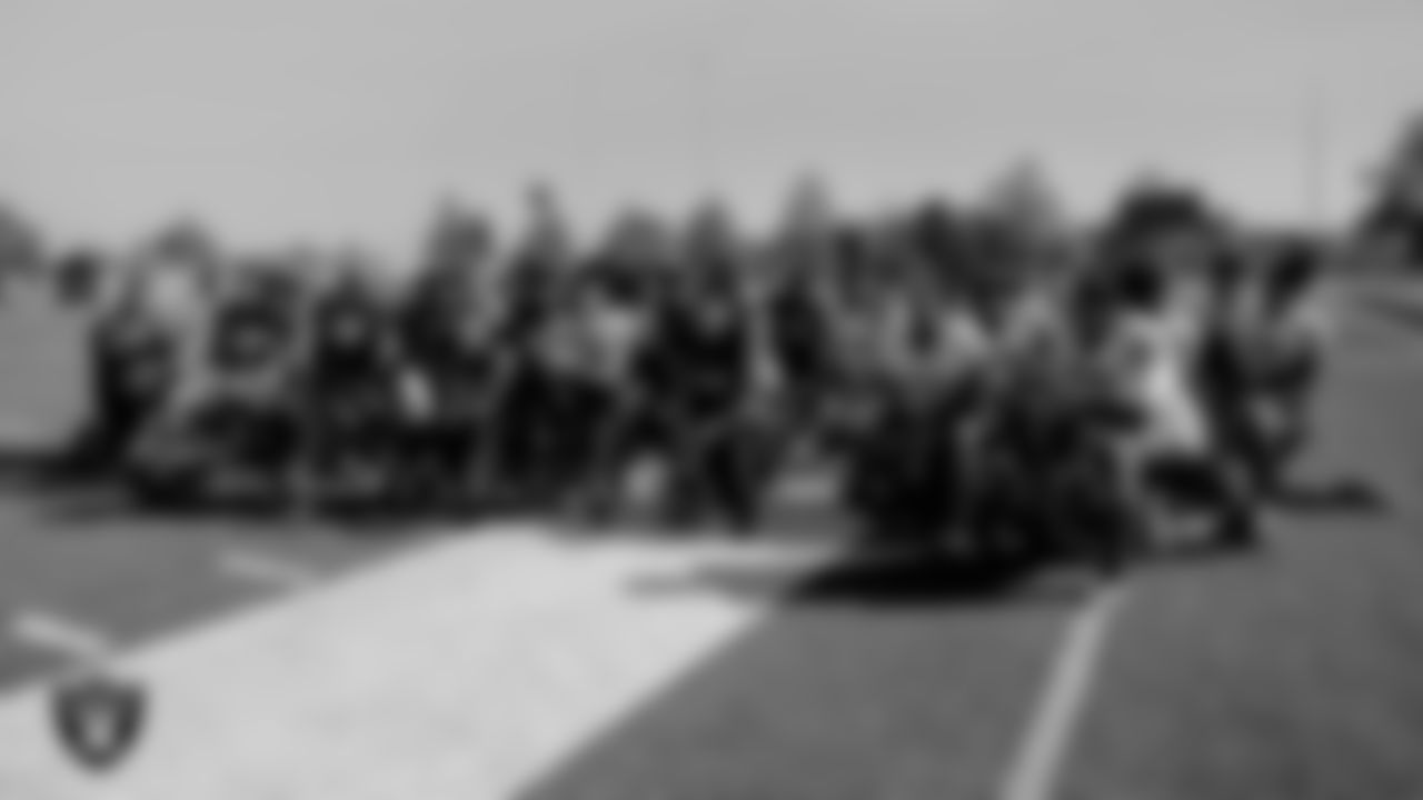 The Desert Pines High School's football team applauds as their coach, Tico Rodriguez, is presented with the Tom Flores High School Coach of the Week award.