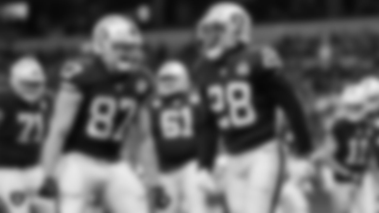 Raiders running back Josh Jacobs (28) celebrates his 12-yard touchdown run with tight end Foster Moreau (87) during the regular season game against the Chicago Bears.