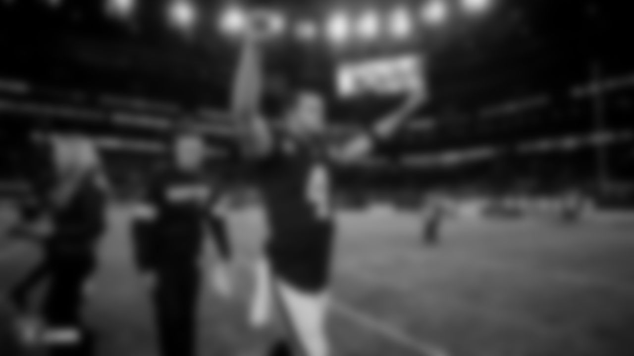 Raiders quarterback Derek Carr (4) celebrates on the field following the regular season game against the Chicago Bears.