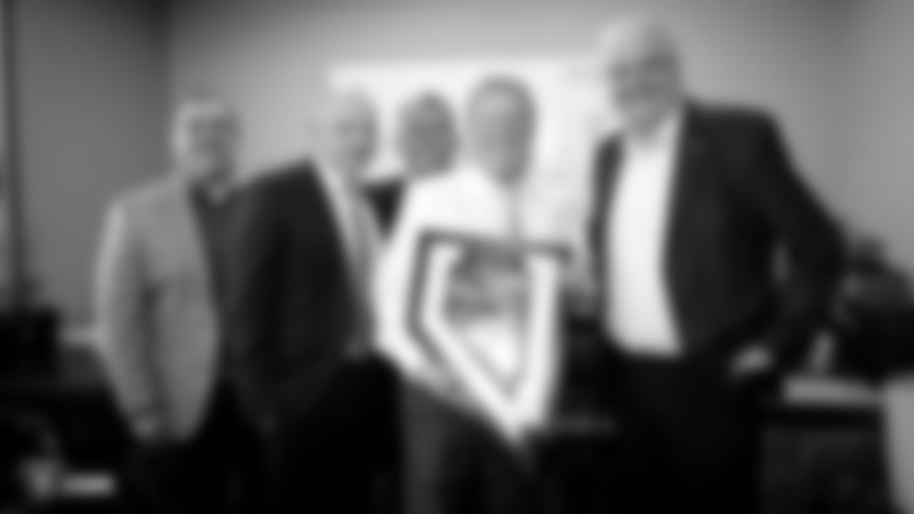 Raiders executive vice president and general counsel Dan Ventrelle, President Marc Badain, Owner Mark Davis, special guest Larry Delsen, and Governor of Nevada Steve Sisolak pose for a photo with a Nevada Raiders plague before an official announcement of the Raiders changing their name to the Las Vegas Raiders.
