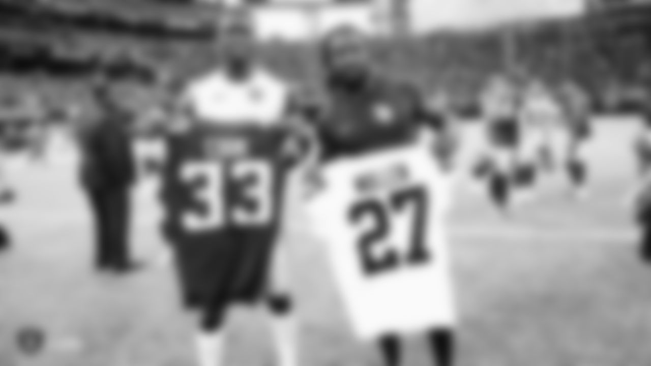 Oakland Raiders cornerback Trayvon Mullen (27) and Minnesota Vikings running back Dalvin Cook (33) after the Oakland Raiders regular season game against the Minnesota Vikings at U.S. Bank Stadium.