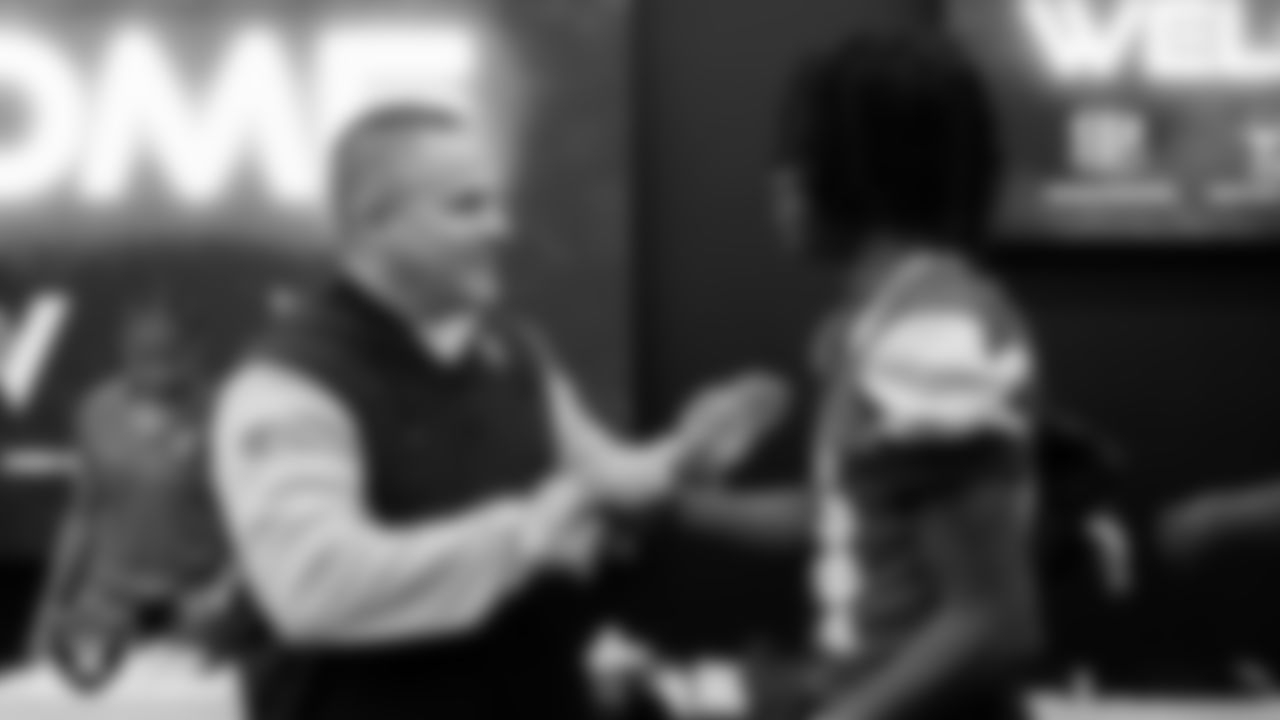 Las Vegas Raiders Head Coach Josh McDaniels shakes hands with a member of the Valley High School football team as they are presented with $5,000 in equipment.