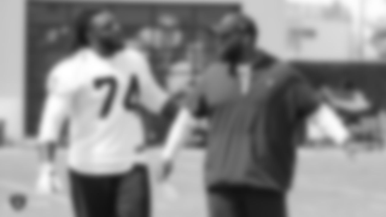 Oakland Raiders assistant offensive line coach Lemuel Jeanpierre talking to tackle TJ Clemmings (74) on the field for practice at the Oakland Raiders Practice Facility, Wednesday, September 12, 2018, in Alameda, California.