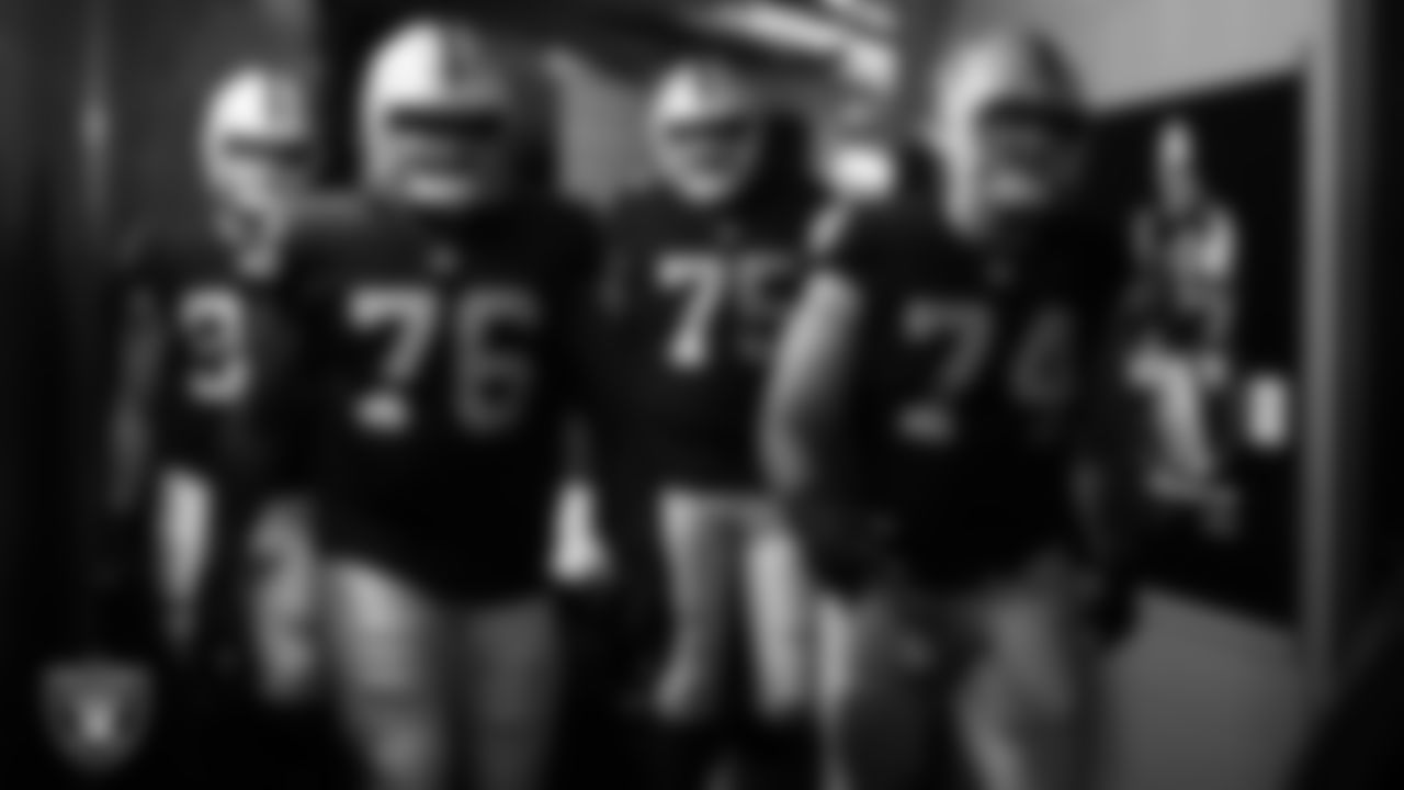 Las Vegas Raiders guard John Simpson (76) and tackle Kolton Miller (74) walk down the tunnel before the regular season home game against the Miami Dolphins .