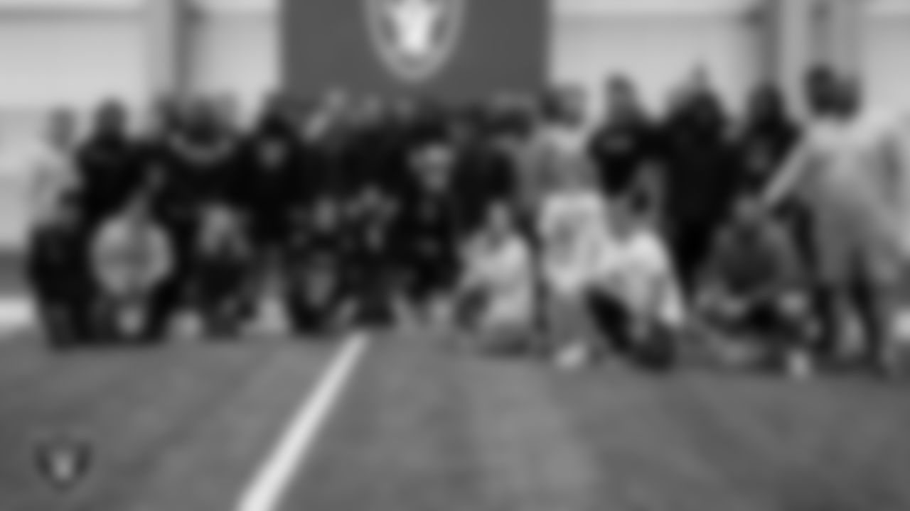 Eli Martinez and William Spooner and their families from the Make-A-Wish Foundation pose for photo with Las Vegas Raiders offense during a visit to Intermountain Healthcare Performance Center.