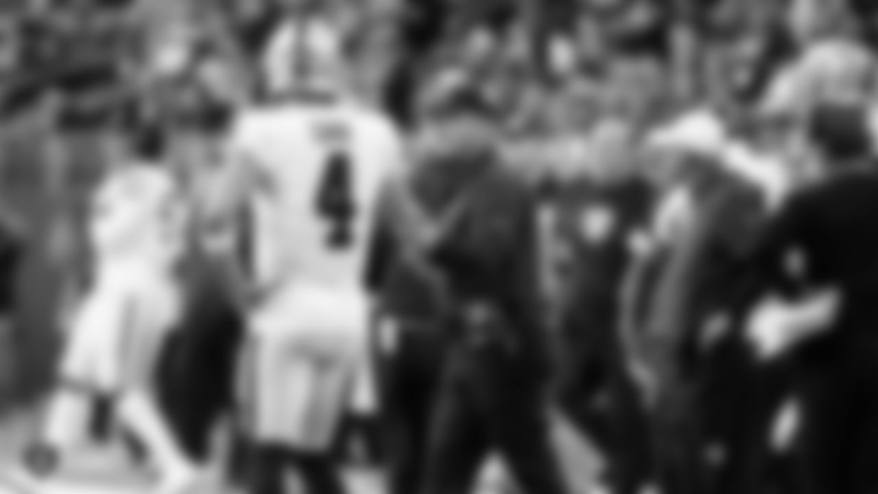 Oakland Raiders quarterback Derek Carr (4) and Head Coach Jon Gruden during the Oakland Raiders regular season game against the Minnesota Vikings at U.S. Bank Stadium.