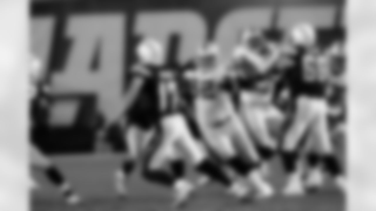 DT Richard Seymour pressures QB Philip Rivers.