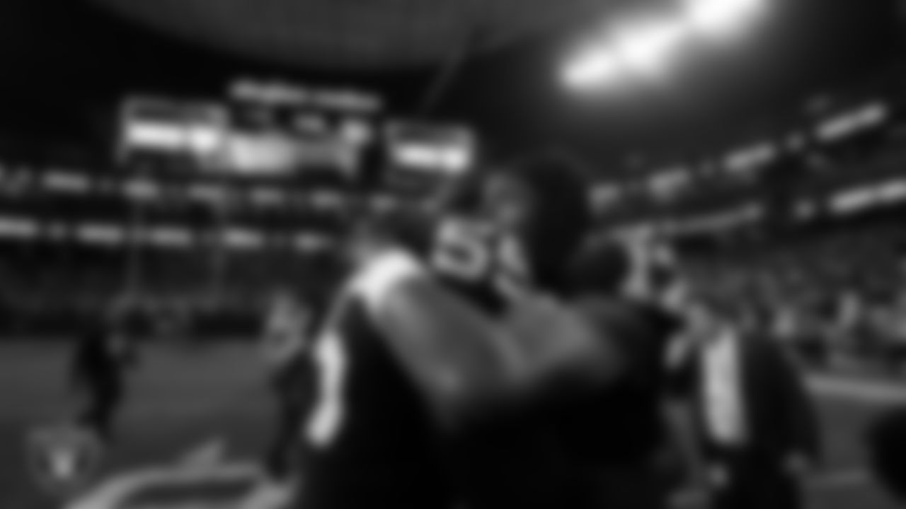 Las Vegas Raiders defensive end Chandler Jones (55) and wide receiver Davante Adams (17) on the field after the regular season home game against the New England Patriots at Allegiant Stadium.