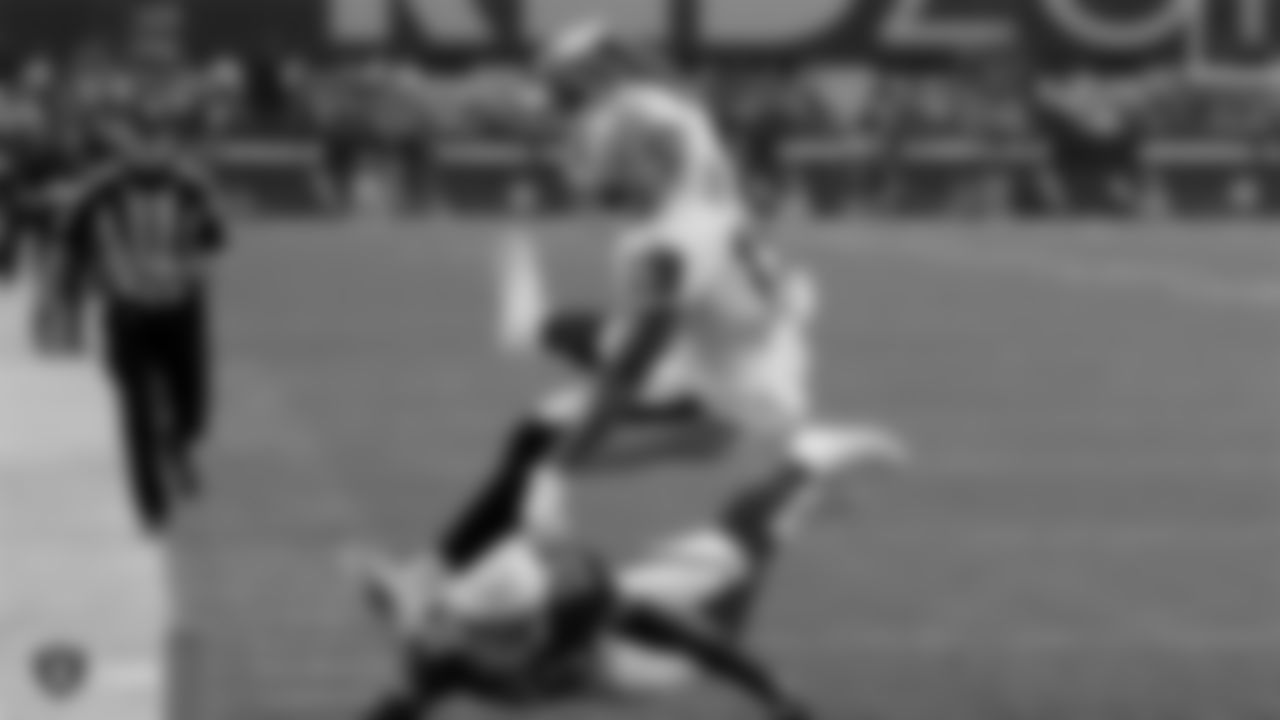 Raiders wide receiver Ryan Grant (19) hurdles over a defender for a touchdown during the Raiders preseason game against the Arizona Cardinals.