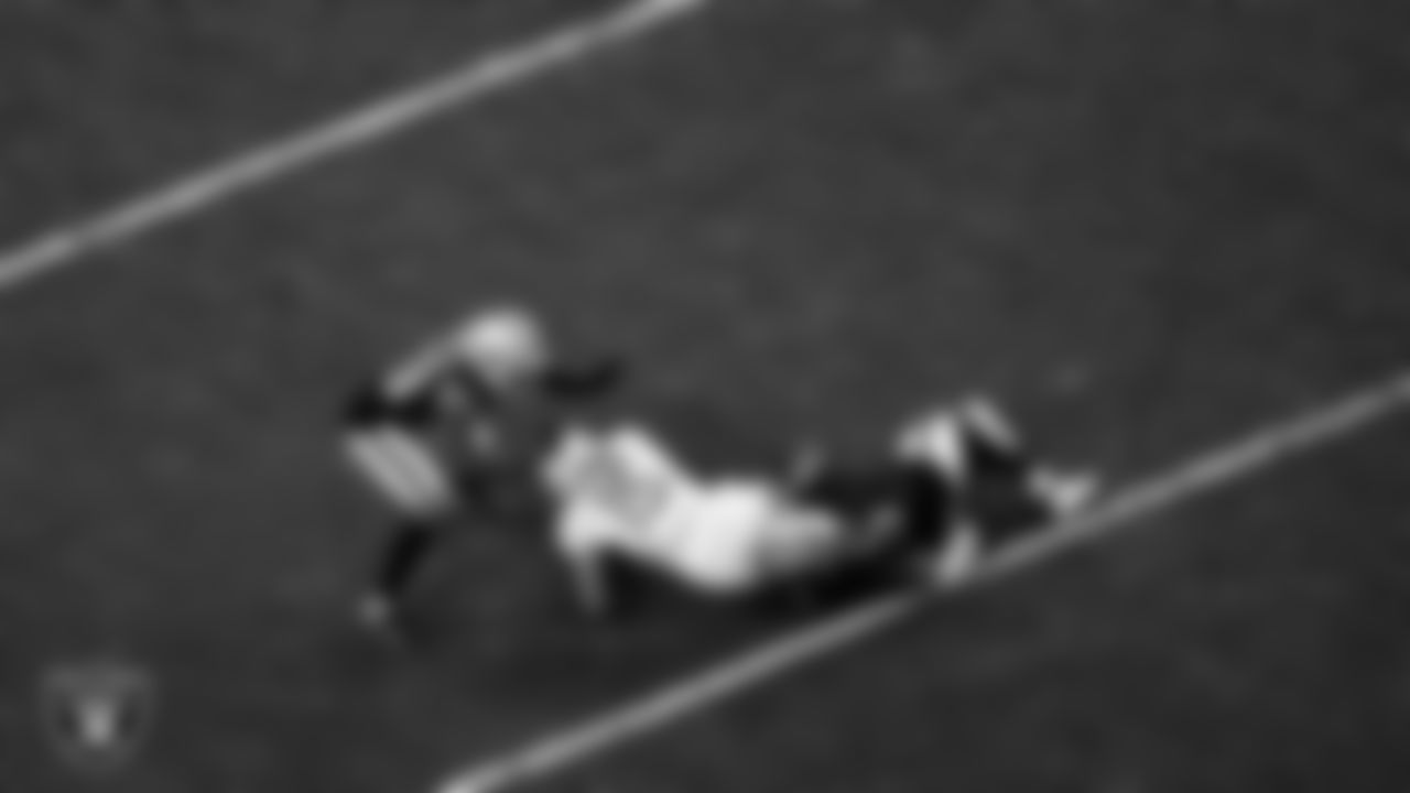 Las Vegas Raiders cornerback Casey Hayward Jr. (29) and linebacker Divine Deablo (5) make a tackle during the regular season home game against the Los Angeles Chargers.