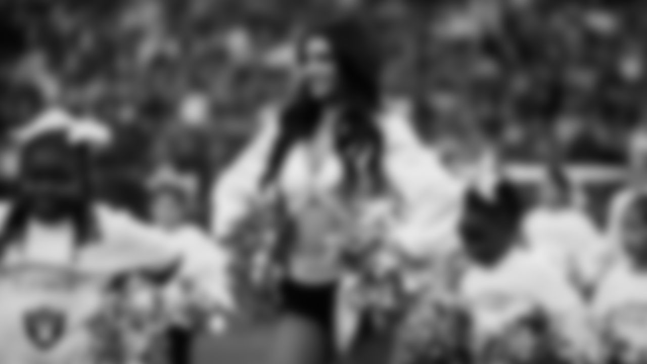 Raiderette Kylee and Junior Raiderettes perform on the field before the regular season home game against the Los Angeles Chargers at Allegiant Stadium.