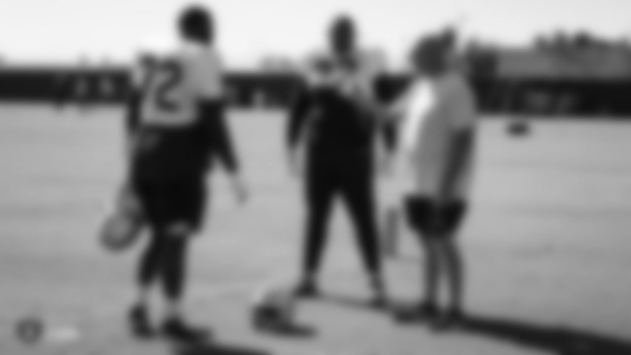 Raiders offensive line coach Tom Cable talks with tackle David Sharpe (72) and tackle Trent Brown (77) during practice.