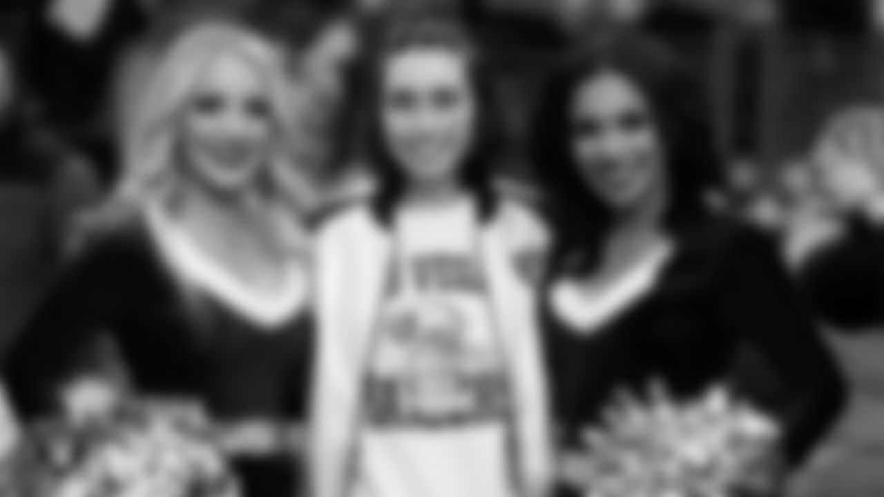 Ella Maldonado of the Make-A-Wish Foundation with Raiderette Melody and Cierra Starnes on the sidelines before the Las Vegas Raiders' regular season home game against the New England Patriots at Allegiant Stadium.