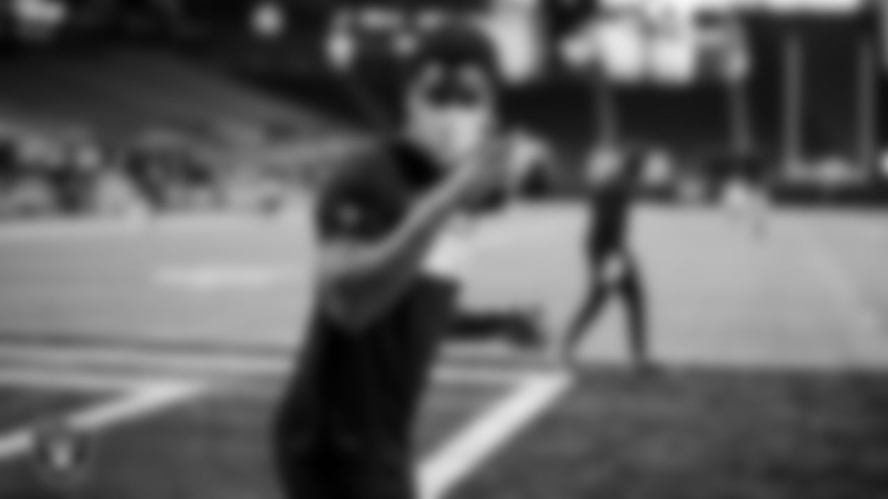 The Raiders warm up before the regular season game against the Atlanta Falcons at Mercedes-Benz Stadium.