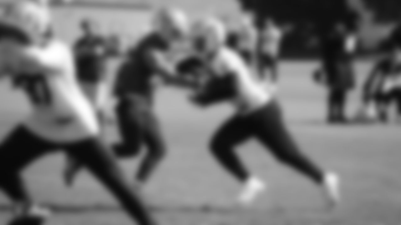 Raiders quarterback Derek Carr (4) hands the ball off to running back Josh Jacobs (28) during practice at the Raiders Practice Facility.