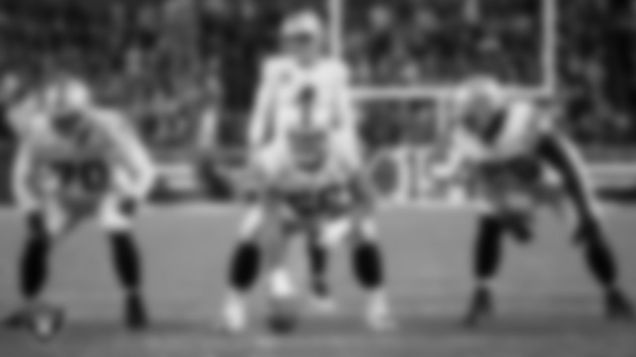 Las Vegas Raiders guard/tackle Alex Leatherwood (70), center Andre James (68), quarterback Derek Carr (4) and guard John Simpson (76) line up before the snap during the regular season away game against the Cleveland Browns.