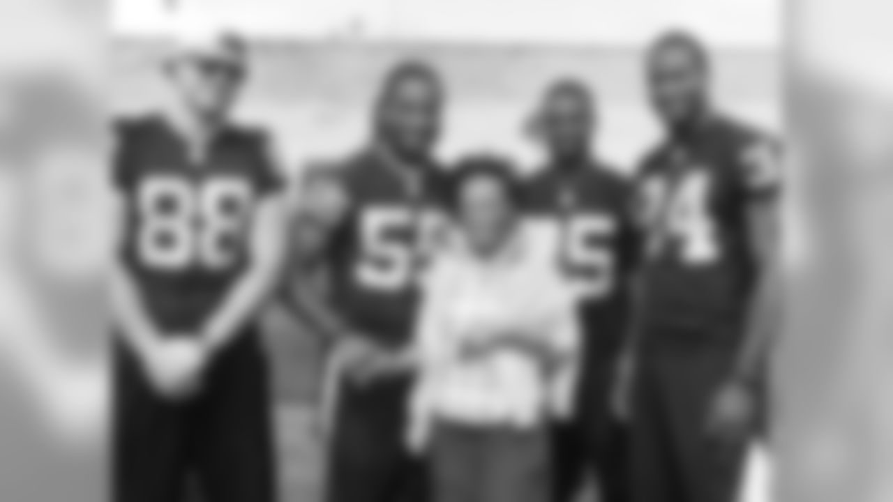 TE Nick Kasa, LB Sio Moore, CB DJ Hayden and RB Latavius Murray pose for a photo with a local resident.