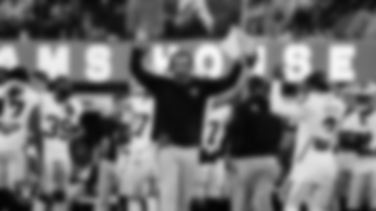 Las Vegas Raiders assistant offensive line coach Cameron Clemmons celebrates wide receiver Cam Sims' (81) 12-yard touchdown catch on the sidelines during the preseason away game against the Los Angeles Rams at Sofi Stadium.