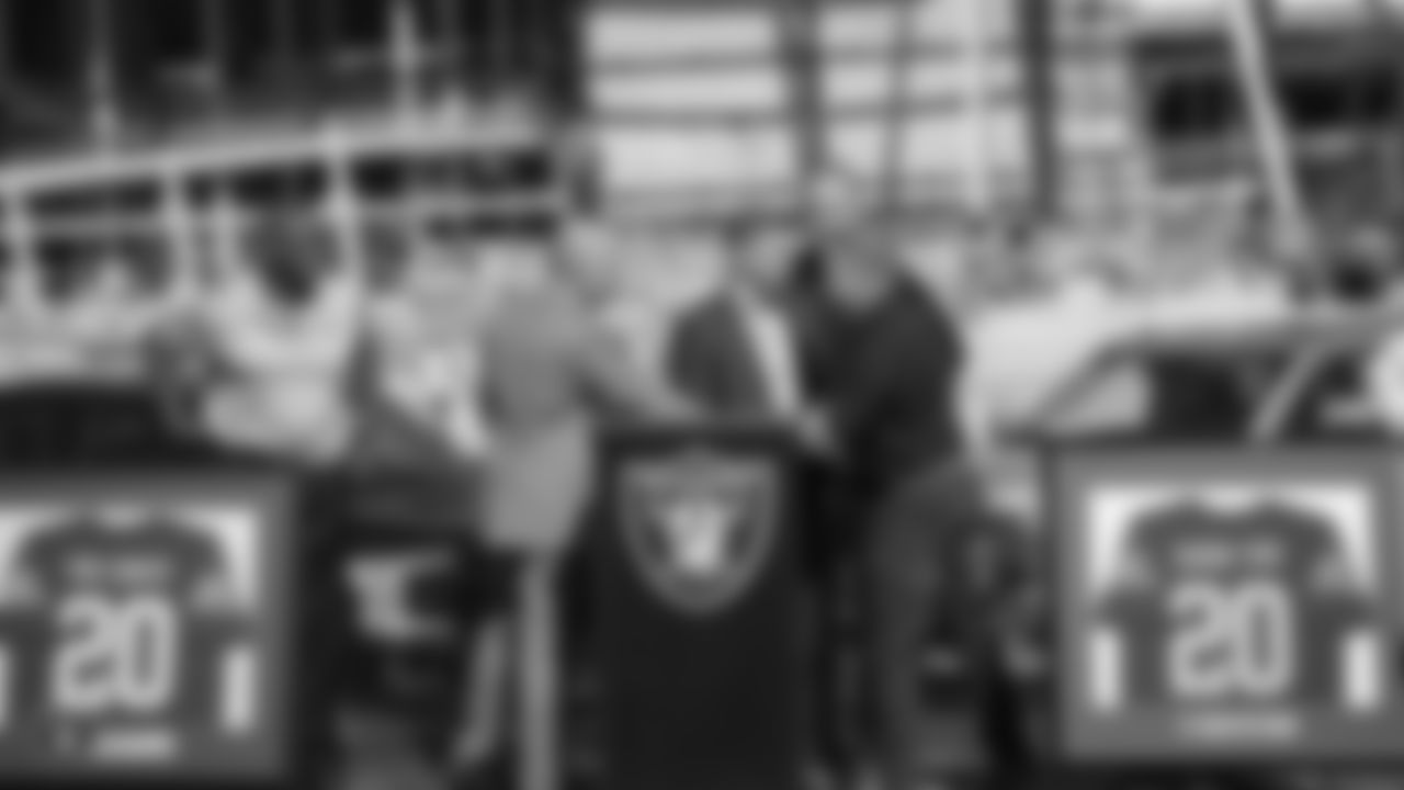 Raiders President Marc Badain shakes hands with Team Ford President Steve Olliges at a private event celebrating Desert Ford Dealers' new partnership with Allegiant Stadium and the Raiders.