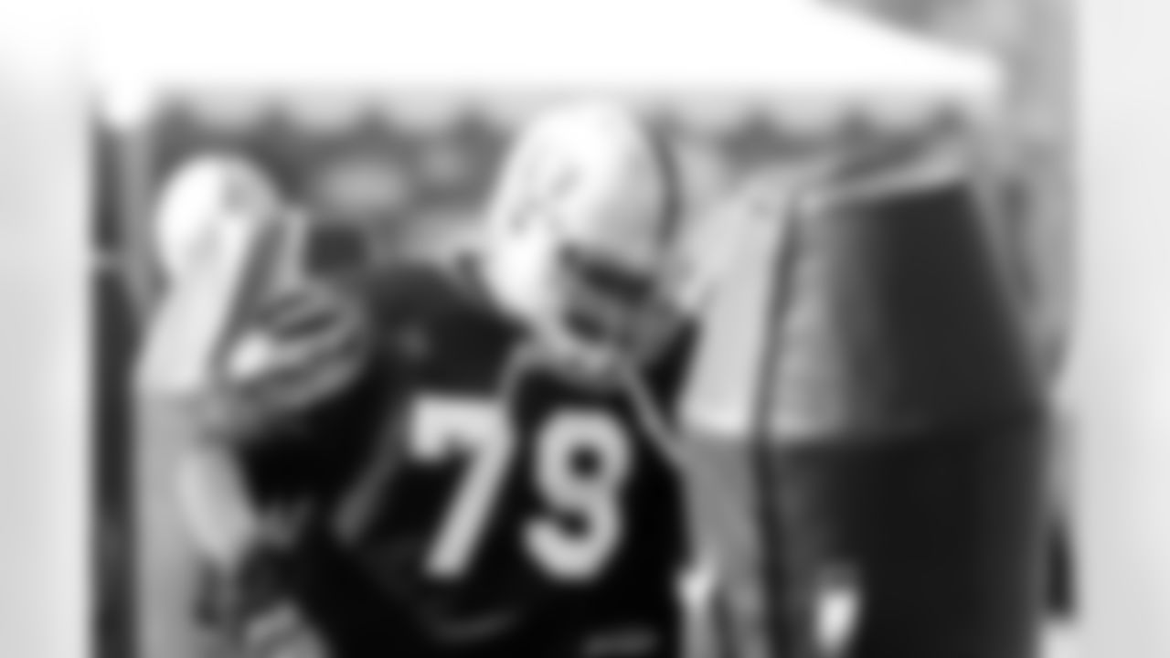 DT John Henderson introduces himself to the tackling dummy. Photo by Tony Gonzales.