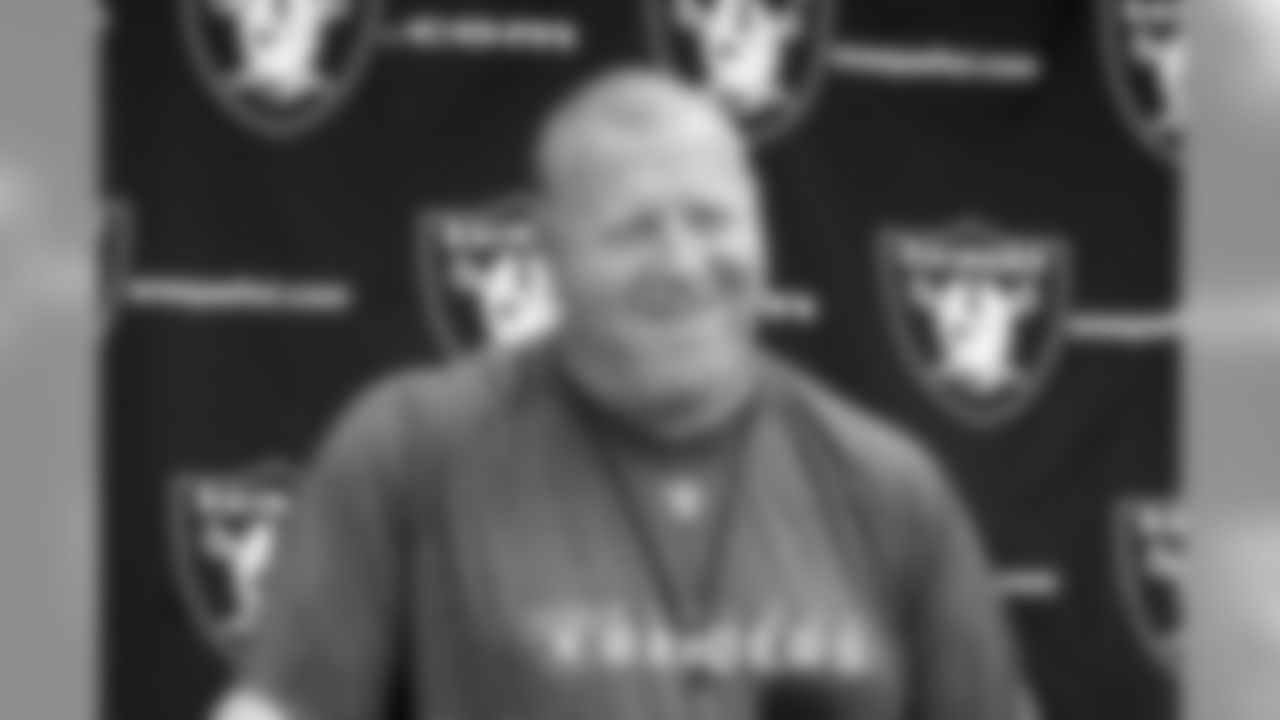 Head Coach Tom Cable smiles while answering questions from the media. Photo By Tony Gonzales.