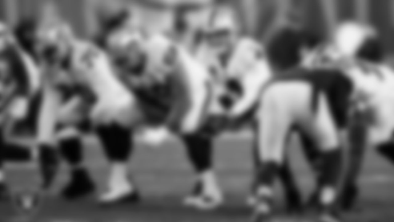 Las Vegas Raiders quarterback Derek Carr (4) receives the snap from center Andre James (68) during the regular season away game against the Cleveland Browns.