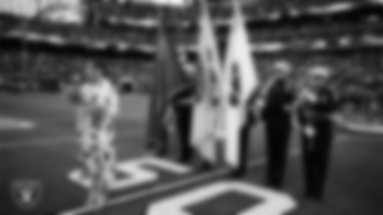 Singer and actress Jojo performs the national anthem, while The Clark County Fire Department presents the nation's colors, before the Las Vegas Raiders' regular season home game against the Houston Texans at Allegiant Stadium.