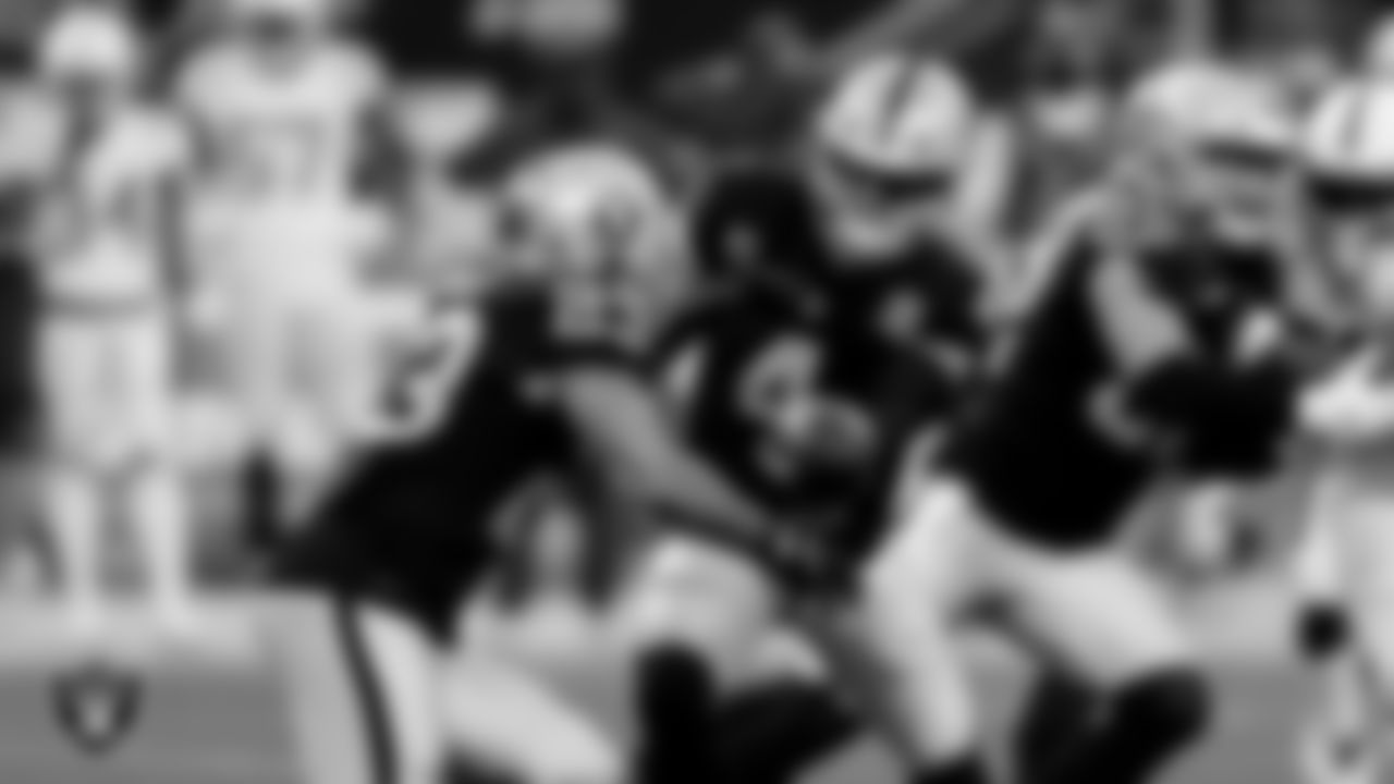 Las Vegas Raiders running back Devontae Booker (23) and quarterback Derek Carr (4) during the regular season game against the Indianapolis Colts at Allegiant Stadium.