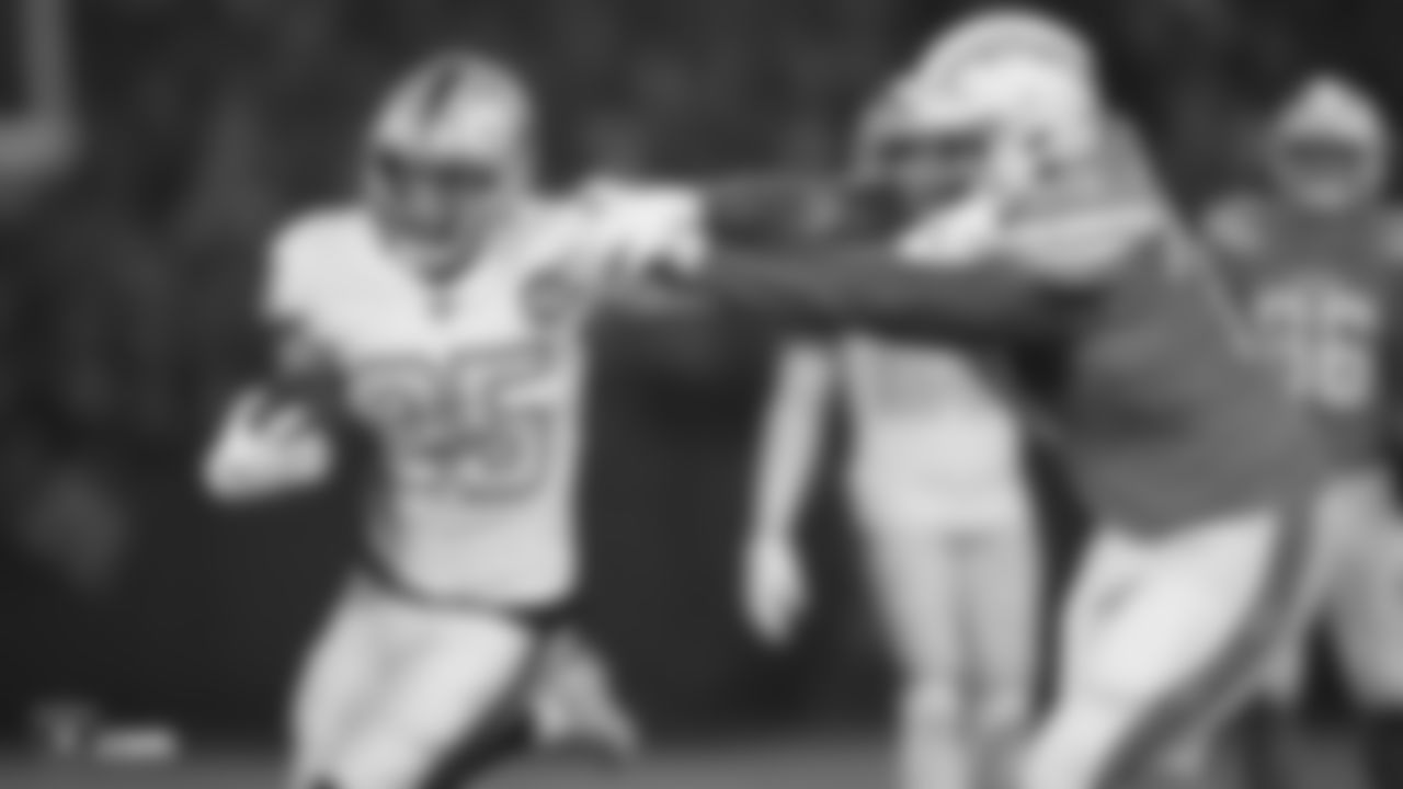 Raiders safety Erik Harris (25) stiff arms the defender while returning an interception 56 yards for a touchdown during the regular season game against the Los Angeles Chargers.
