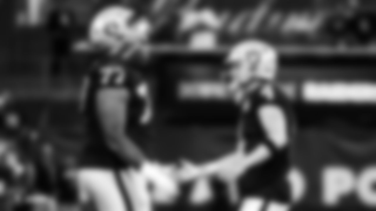 Raiders tackle Trent Brown (77) and quarterback Derek Carr (4) during the Raiders regular season game against the Denver Broncos.